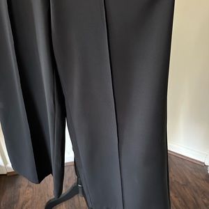 Black suit by Nancy, Top is XL, pants is large. Zipper in the back with wide leg